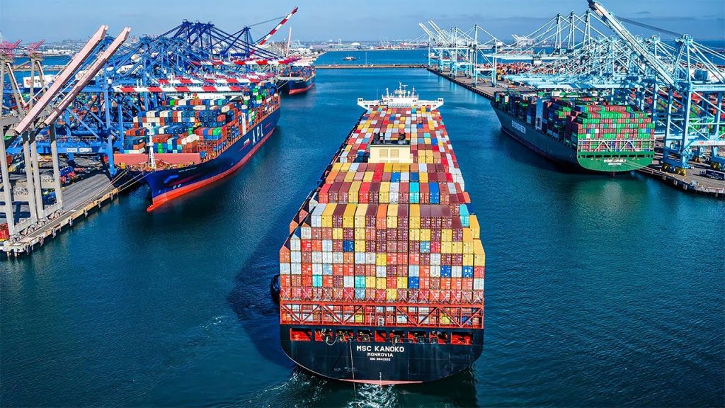 A bustling port with large container ships docked and fully loaded, showcasing global freight and shipping activity.