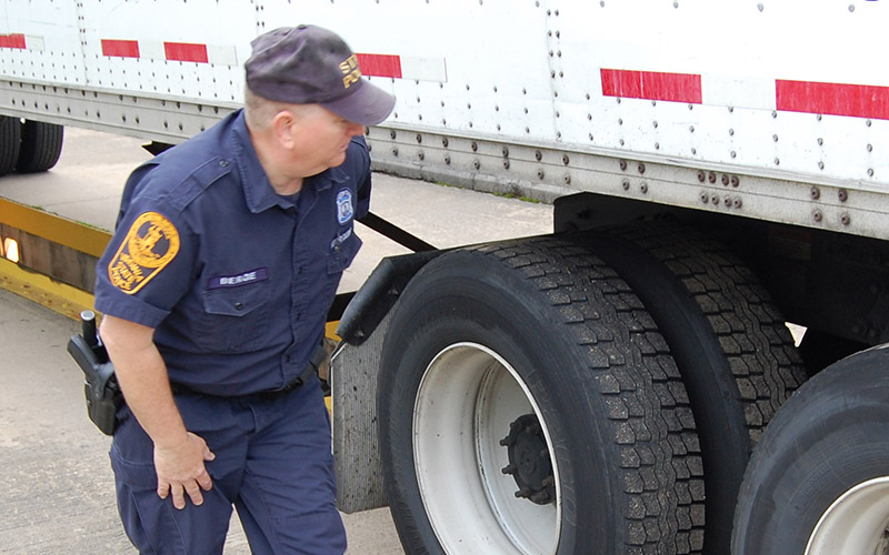DOT officer conducting roadside truck inspection during CVSA Roadcheck